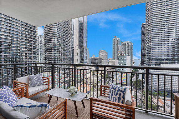 Balcony view of city skyline with modern high-rise buildings.