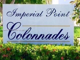 Sign reading 'Imperial Point Colonnades' surrounded by greenery.