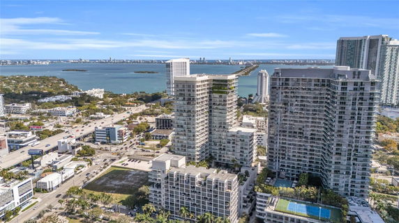 Wide angle view of tall buildings near a water body.