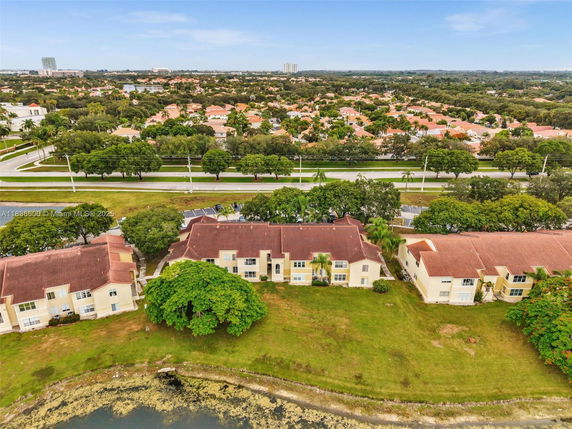 Aerial view of residential area with multiple houses and greenery.