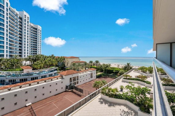 View from a building showing nearby structures and a beachside area.