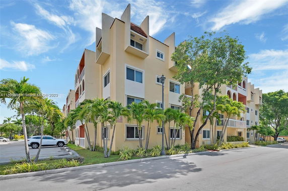 Front view of a multi-story apartment building with angular designs and balconies.