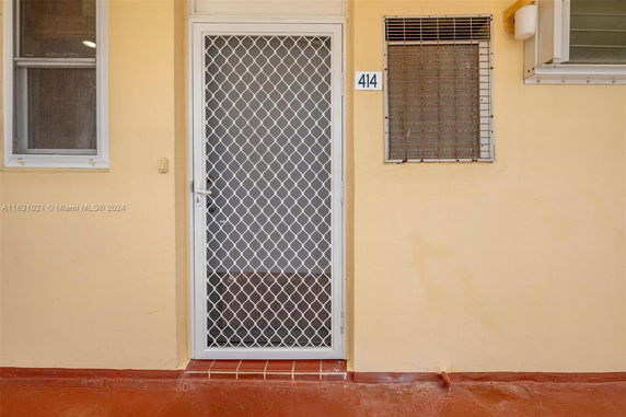 Front view of a building entrance with a metal security door.