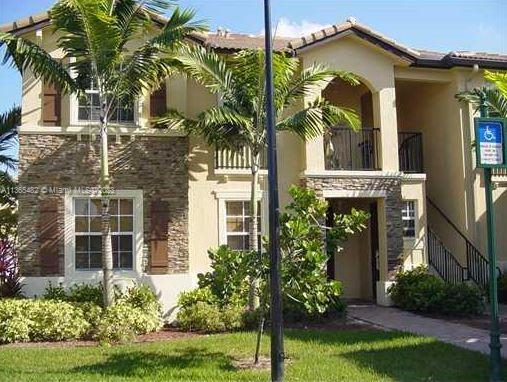 Front view of a two-story house with stone facade accents and balcony.