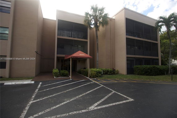 Front view of a building with multiple floors and a covered entrance.