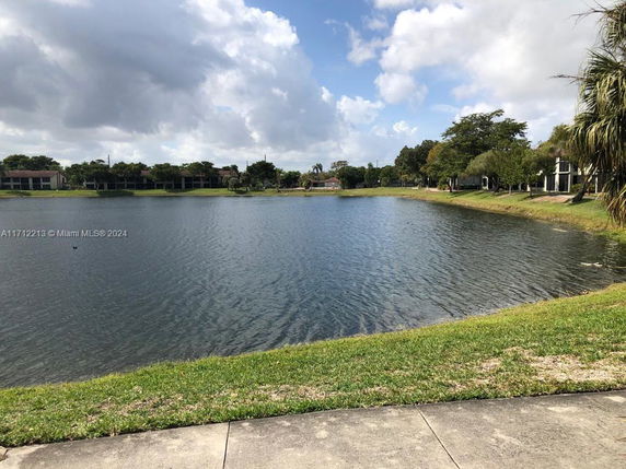 View of a lake with residential buildings in the background