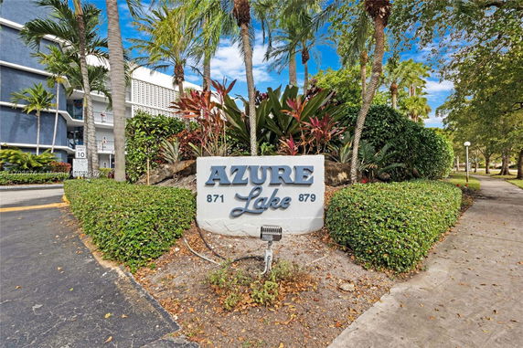 Front view of a residential building entrance with signage.