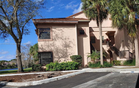 Front view of a two-story residential building with an exterior staircase.