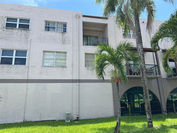 Front view of a three-story residential building with balconies.