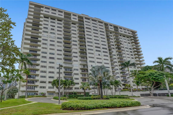 Front view of a multi-story residential building with balconies.