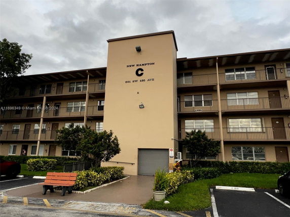 Front view of a multi-story residential building with a central entrance.