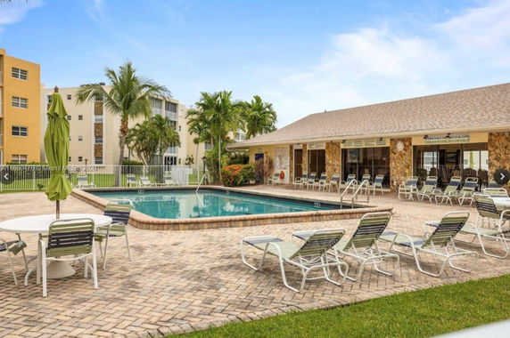 Outdoor area with a swimming pool and adjacent seating.