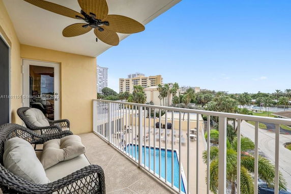 View of surrounding buildings and area from a balcony with outdoor chairs.