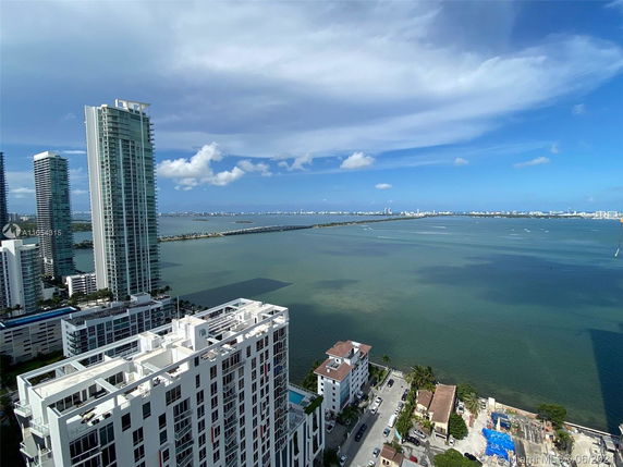 Panoramic view of tall residential buildings near a body of water.