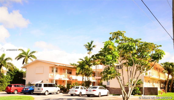 Front view of a two-story apartment building with multiple balconies.