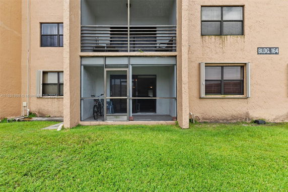 Front view of a multi-story building with screened balconies.