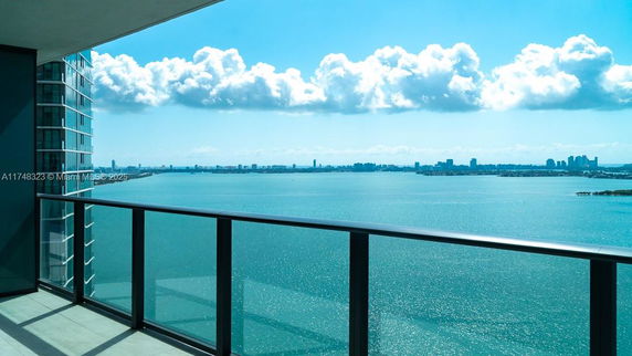 Panoramic view of a body of water from a building balcony.