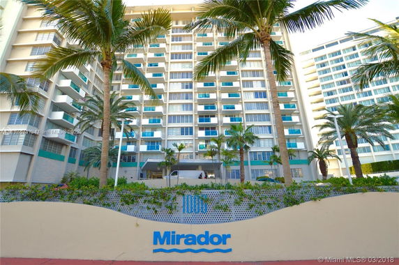 Front view of a multi-story residential building with balconies.