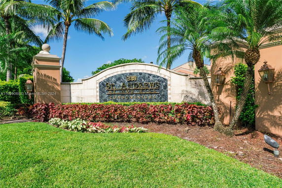 Entrance sign for St. Andrews at Nob Hill Condominiums surrounded by palm trees and landscaping.