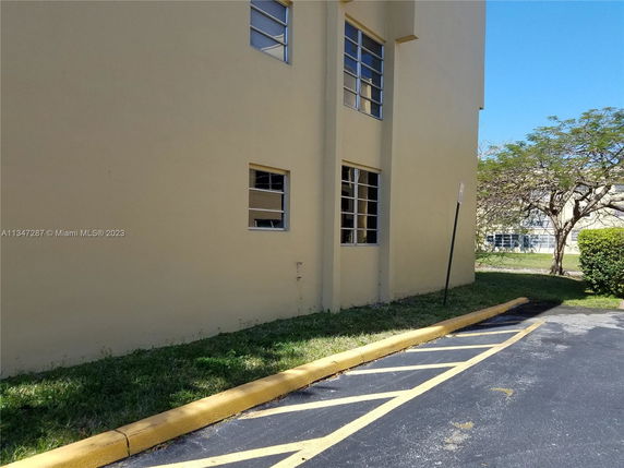 Side view of a beige building with multiple windows