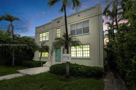 Front view of a two-story building with large windows and decorative elements.