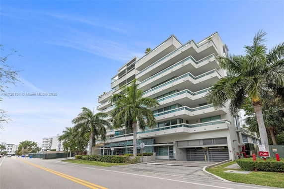 Front view of a multi-story residential building with balconies.
