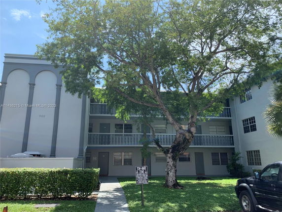 Front view of a multi-story residential building with balconies.