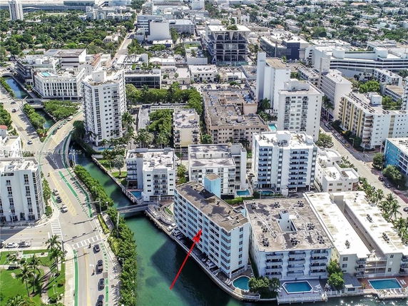 Aerial view of a cityscape with multiple residential buildings and a canal.