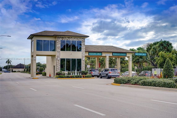 Front view of a guardhouse with multiple entry lanes for visitors and residents.