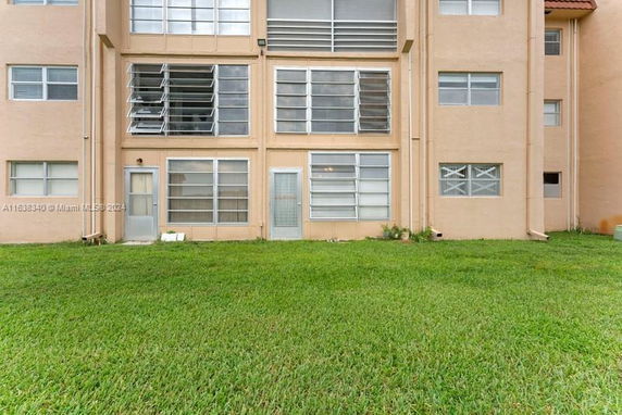 Exterior view of a multi-story building with multiple windows and doors.