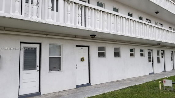 Front view of a multi-story building with balconies.
