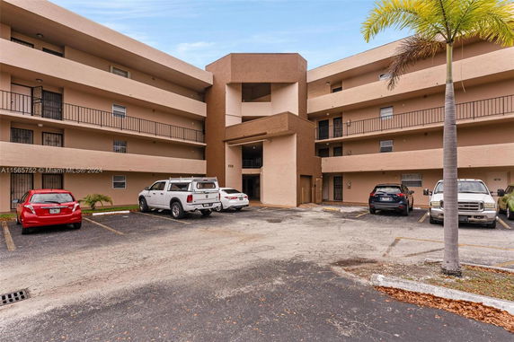 Front view of a multi-story apartment building with balconies.