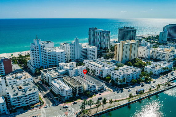 Aerial view of a coastal urban area with multiple high-rise buildings near the ocean.