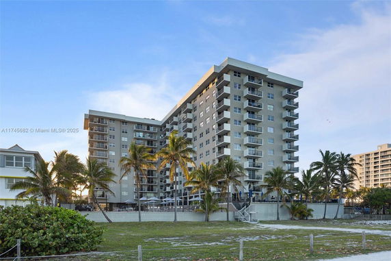 Front view of a multi-story residential building with balconies.