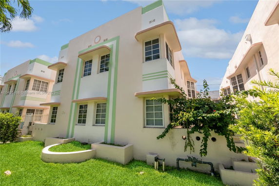Front view of a multi-story building with pastel-colored geometric designs.