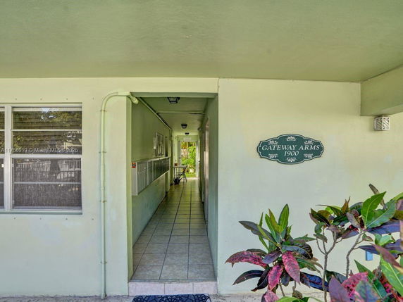 Front view of a building entrance with signage 'Gateway Arms 1900'.