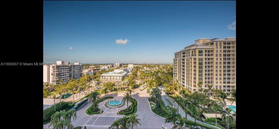 Elevated view of luxury residential and commercial buildings with landscaped areas and roads.