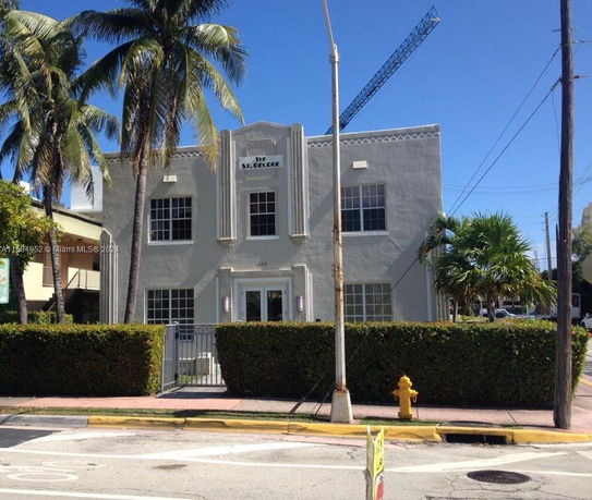 Front view of a two-story building with a decorative facade.