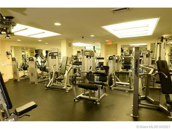 Indoor gym area with various exercise machines and equipment.
