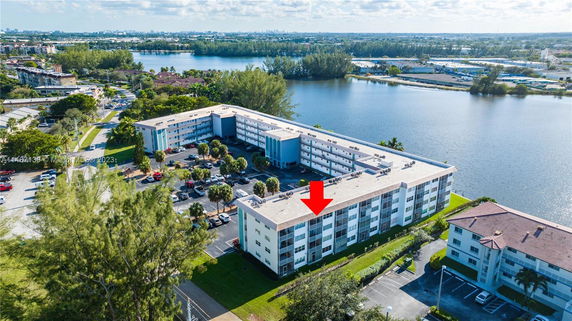 Aerial view of apartment buildings near a large water body.