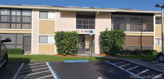 Front view of a two-story apartment building with a central staircase.