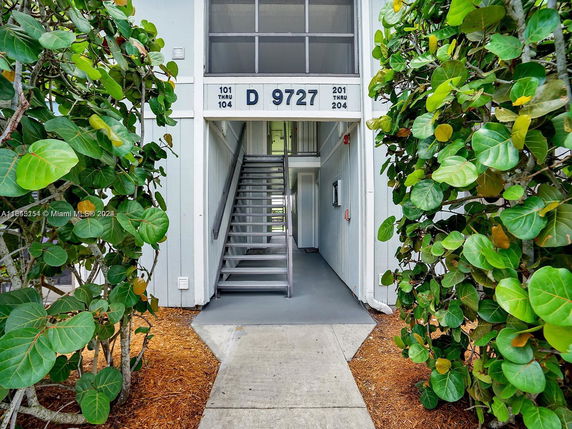 Front view of a building entrance with an exterior staircase.