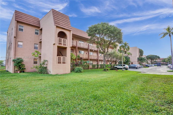 Front view of a multi-story apartment building with balconies.