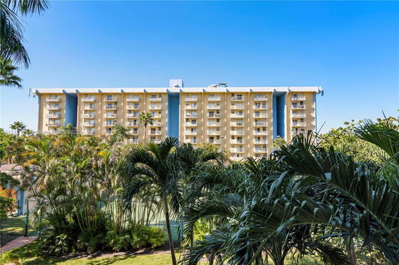 Front view of a multi-story residential building with balconies.