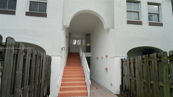 Front view of a building with an archway and staircase