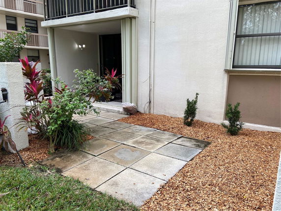 Front view of a ground-floor unit with a small patio area.