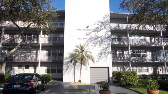 Front view of a multi-story residential building with balconies.