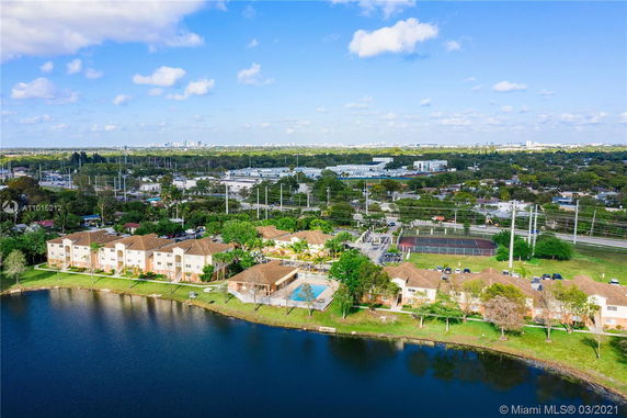 Panoramic view of residential buildings near a lake with surrounding cityscape