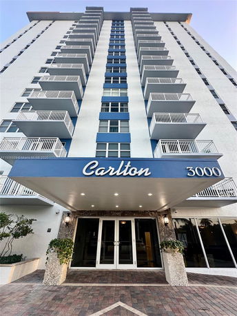 Front view of a multi-story building with multiple balconies.