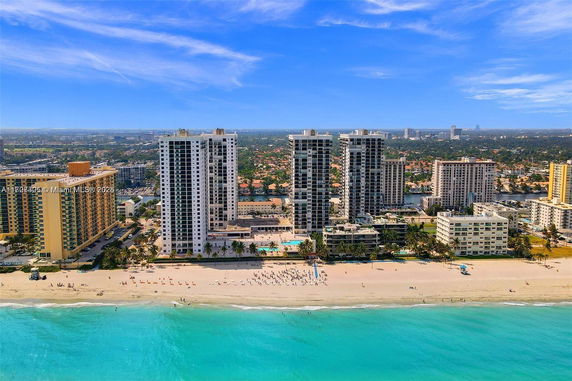 Coastal view of high-rise buildings near the beach with a clear skyline.